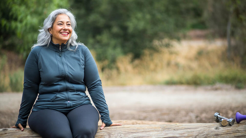 Magnesium and menopause, happy woman sitting on tree outside