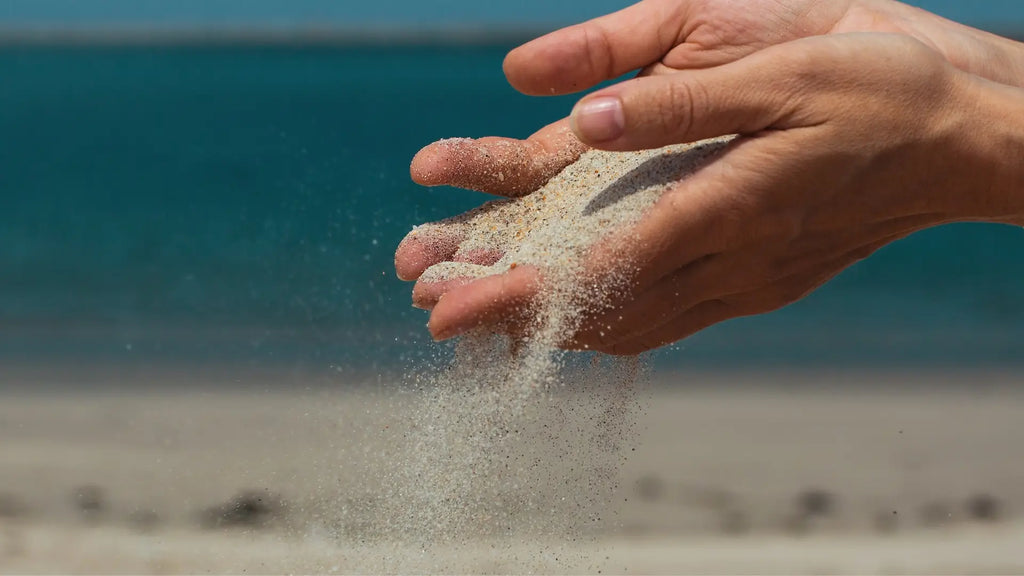 Sand slipping through fingers
