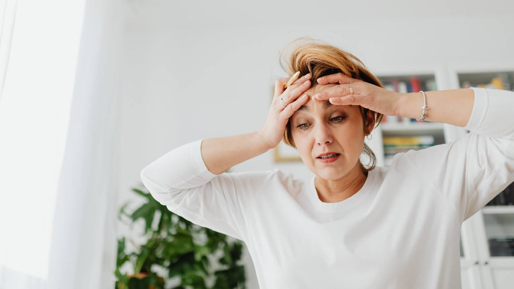 Stressed woman holding her head