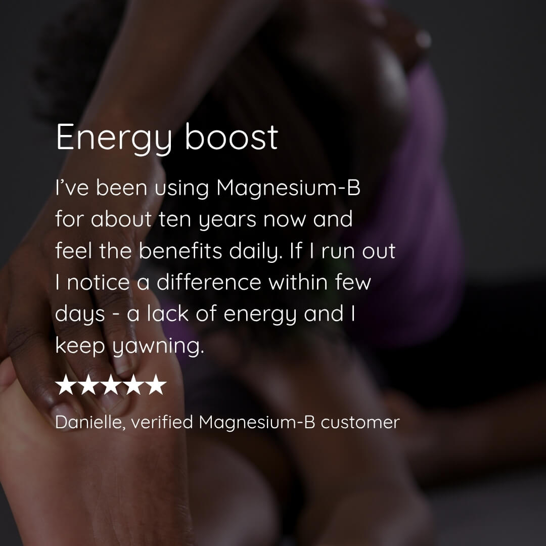 A testimonial-style graphic with a blurred photo of a person sitting and wrapped in a purple blanket, overlaid with white text reading 'Energy boost' and a customer review for Magnesium-B. No actual product package is visible.