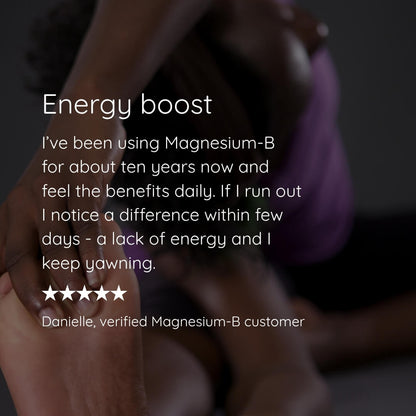 A testimonial-style graphic with a blurred photo of a person sitting and wrapped in a purple blanket, overlaid with white text reading 'Energy boost' and a customer review for Magnesium-B. No actual product package is visible.