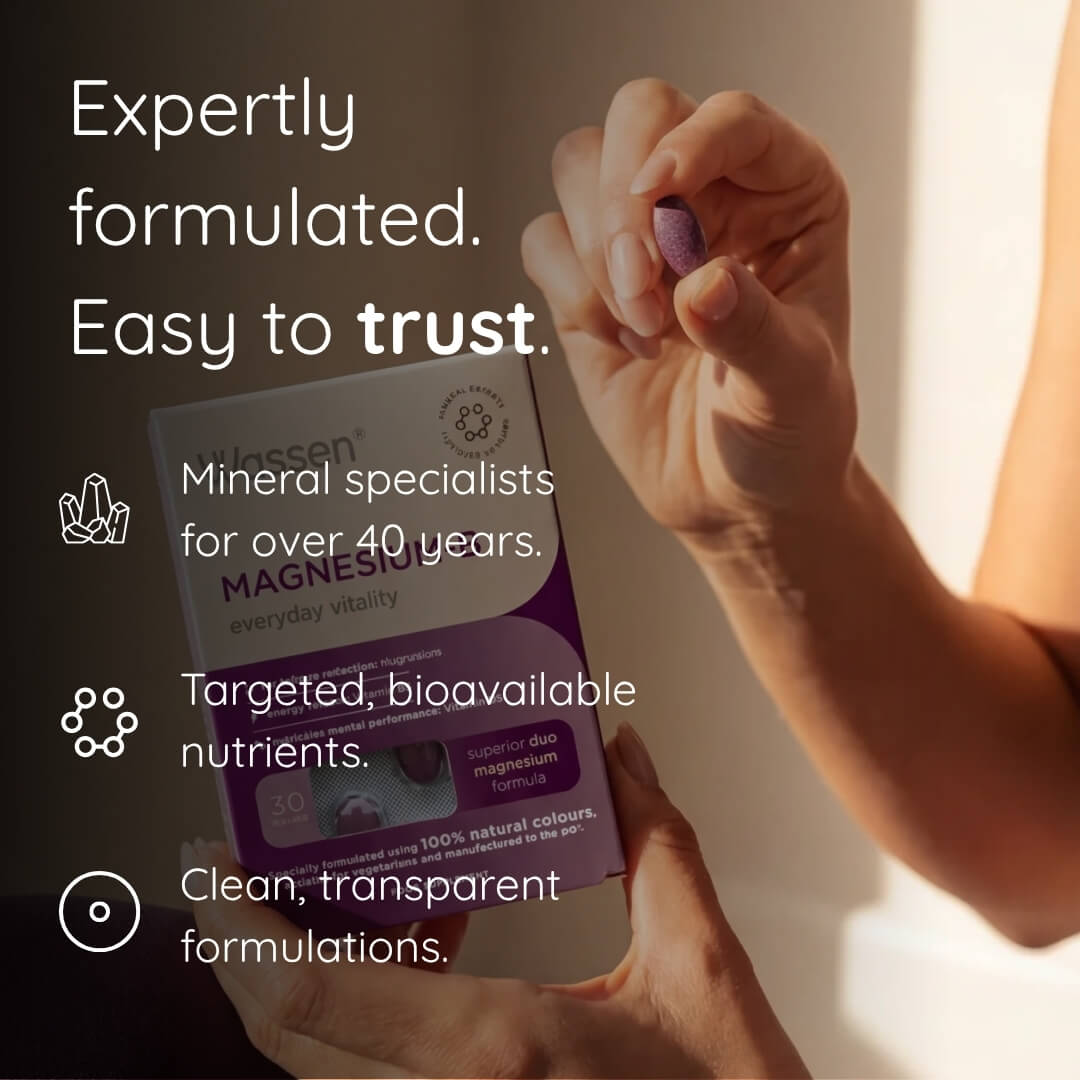 A person holds a box of Vitacel Magnesium supplement in one hand while holding a single purple tablet in the other, with promotional text on a dark background.