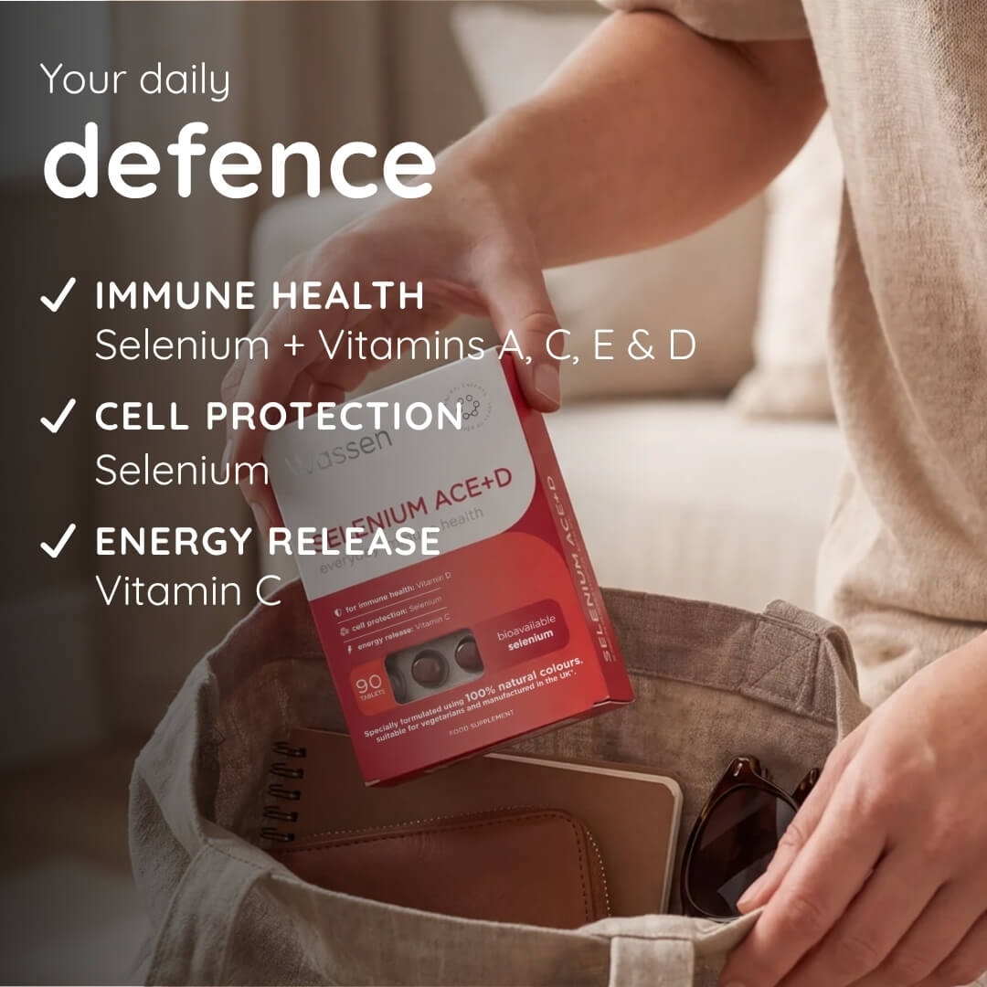 A person holding a red and white box of Selenium Prime ACE+D supplement, placing it into a beige canvas tote bag. The image features promotional text overlays highlighting the benefits of the product, including immune health, cell protection, and energy release.