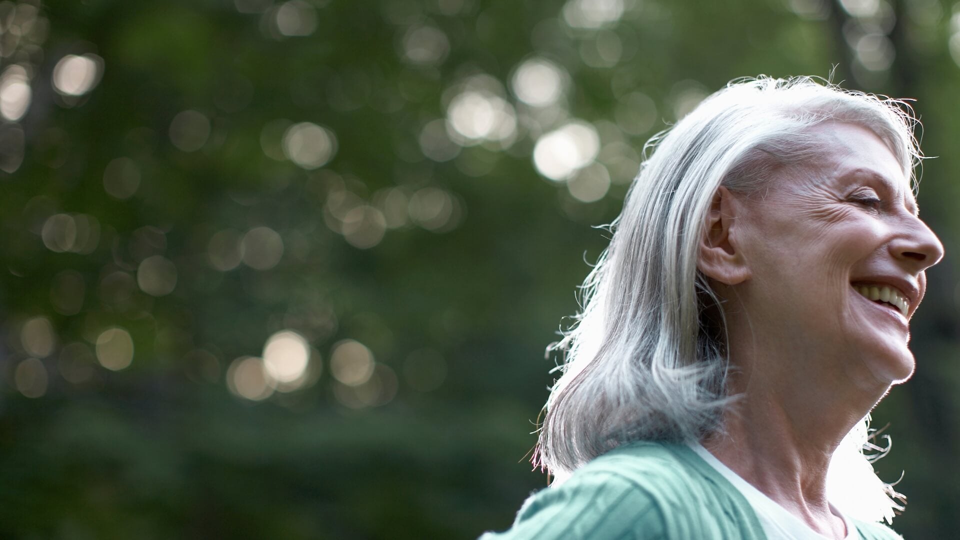 happy woman outside smiling in nature